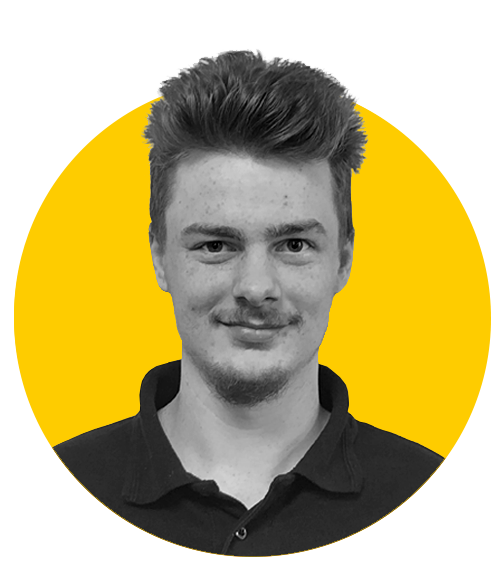 A monochrome photo of Tom against a yellow background